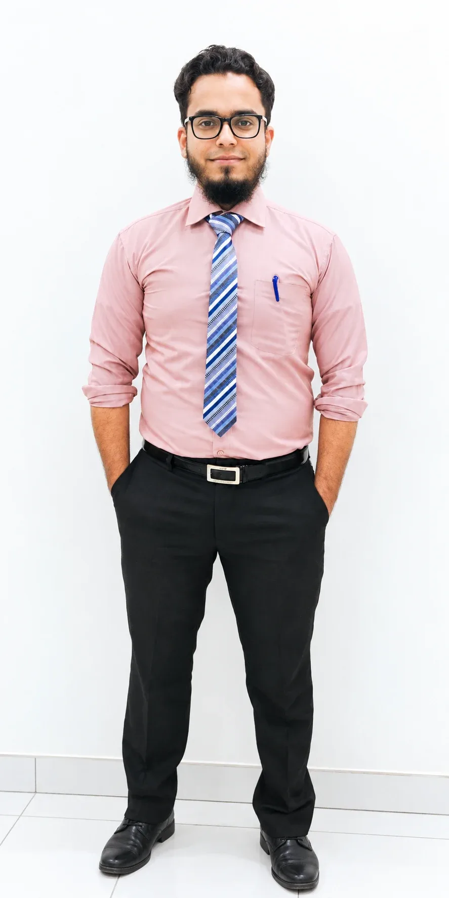 Maaz Ahmed, smiling, wearing glasses, a pink shirt and a blue striped tie