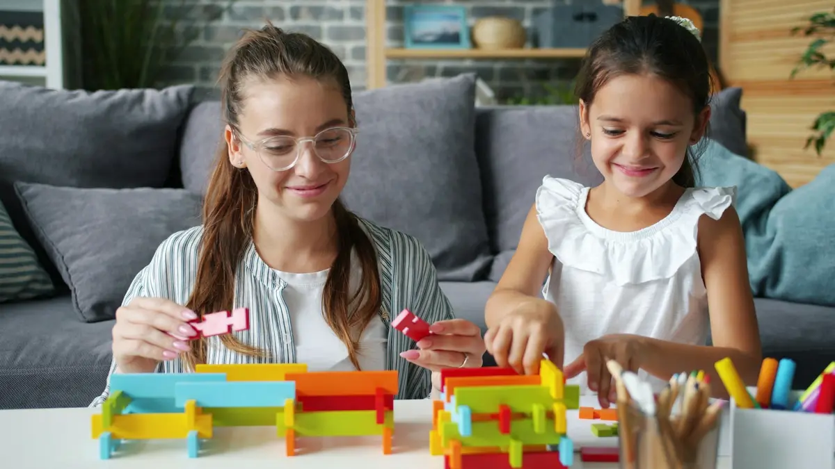 Adult and child building together with colourful blocks